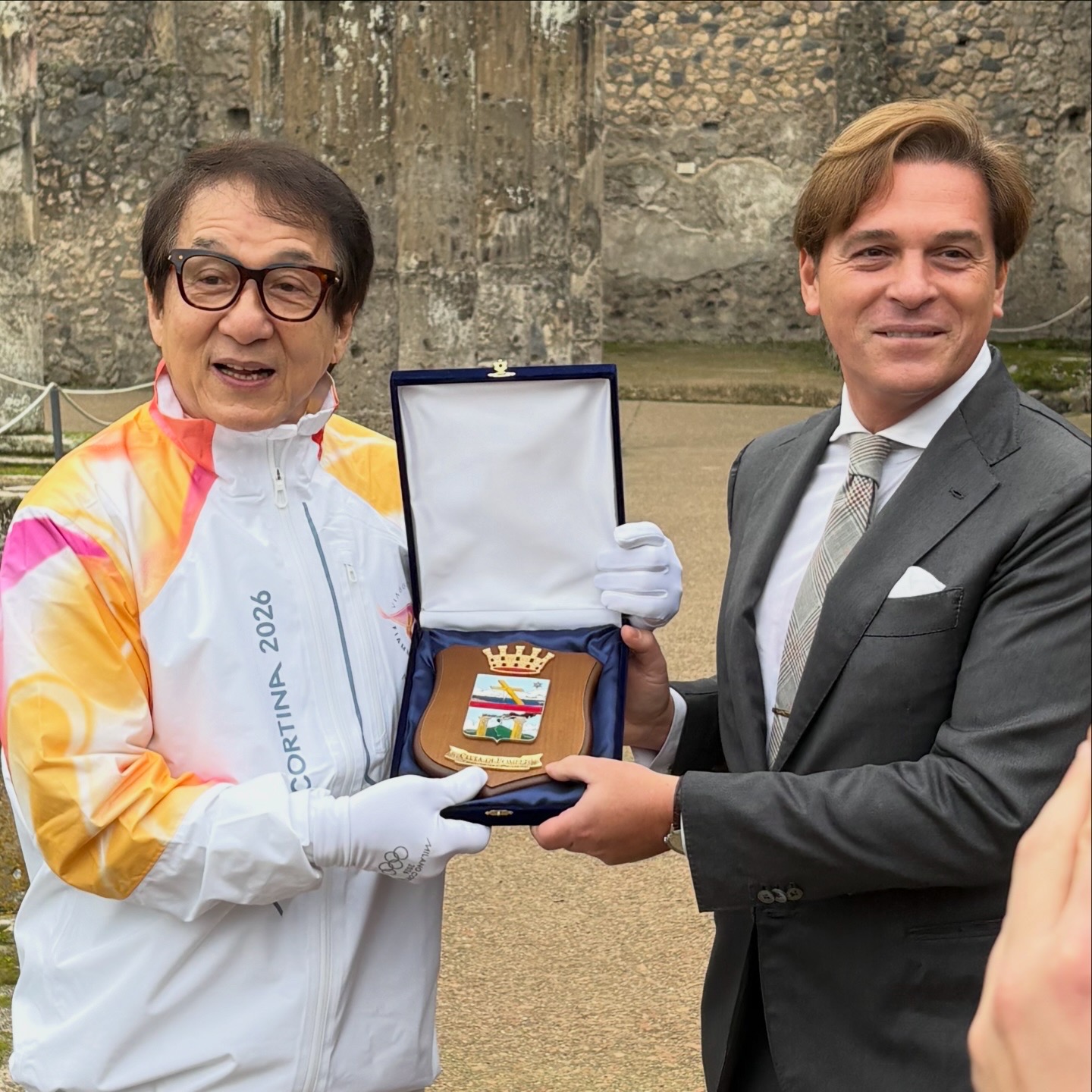 Mario Muscariello with Jackie Chan during the Milano Cortina 2026 Olympic Flame journey in Pompeii